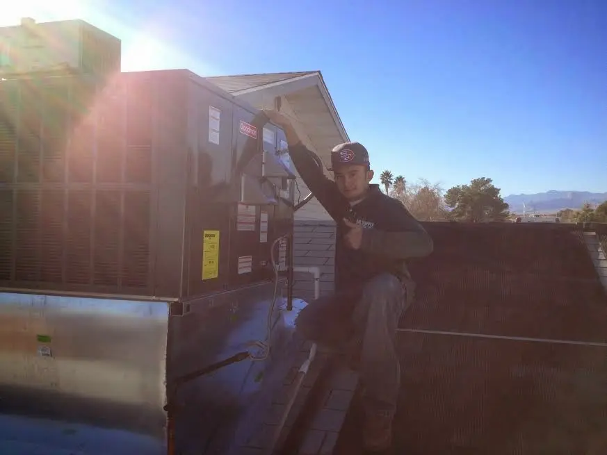HVAC technician performing HVAC Inspection on a rooftop unit in La Homa